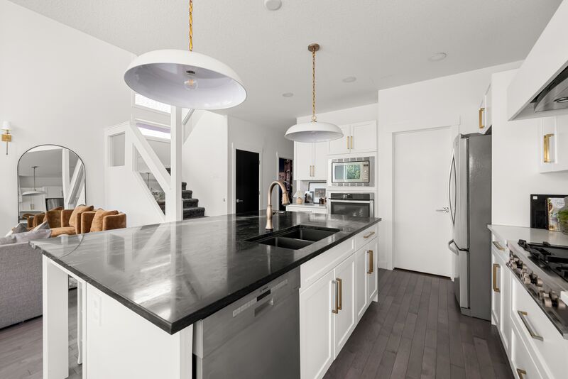 Kitchen with island, pendant lighting and gold hardware