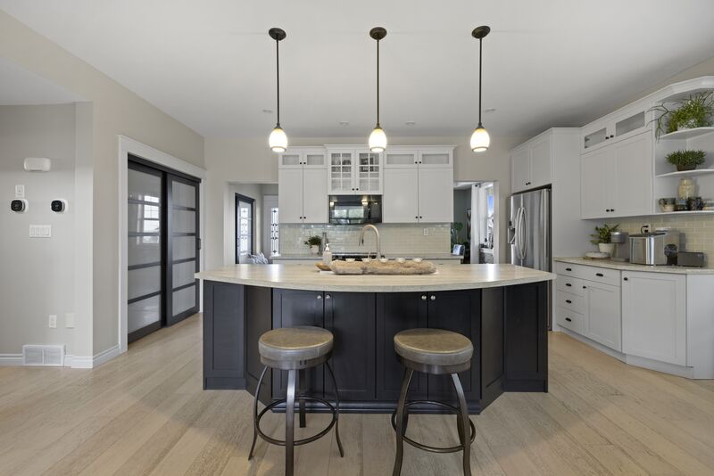 Kitchen with white cabinetry and pendant lighting