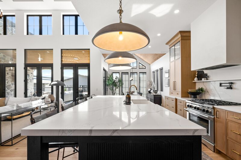 Kitchen with dark cabinetry and gold pendant lighting