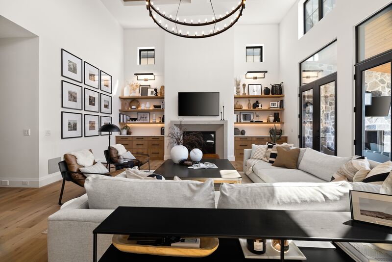 Living room with vaulted ceiling, gallery wall and statement chandelier