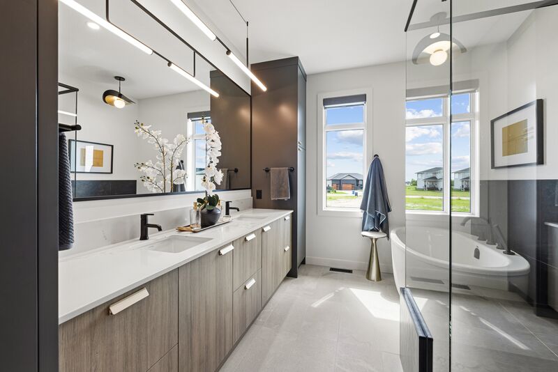 Primary ensuite with a glass walk-in shower and freestanding tub
