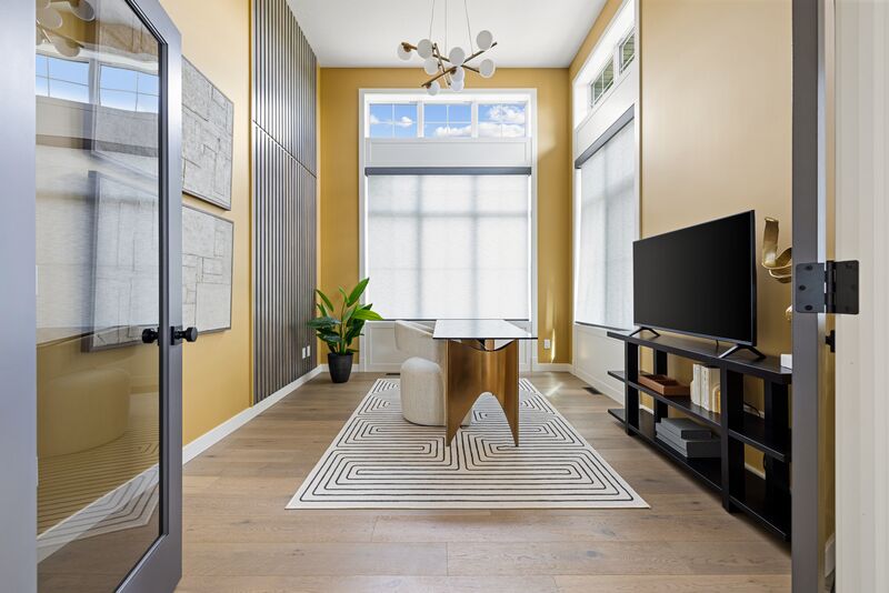 Home office with mustard walls and a vertical wood-slat accent wall
